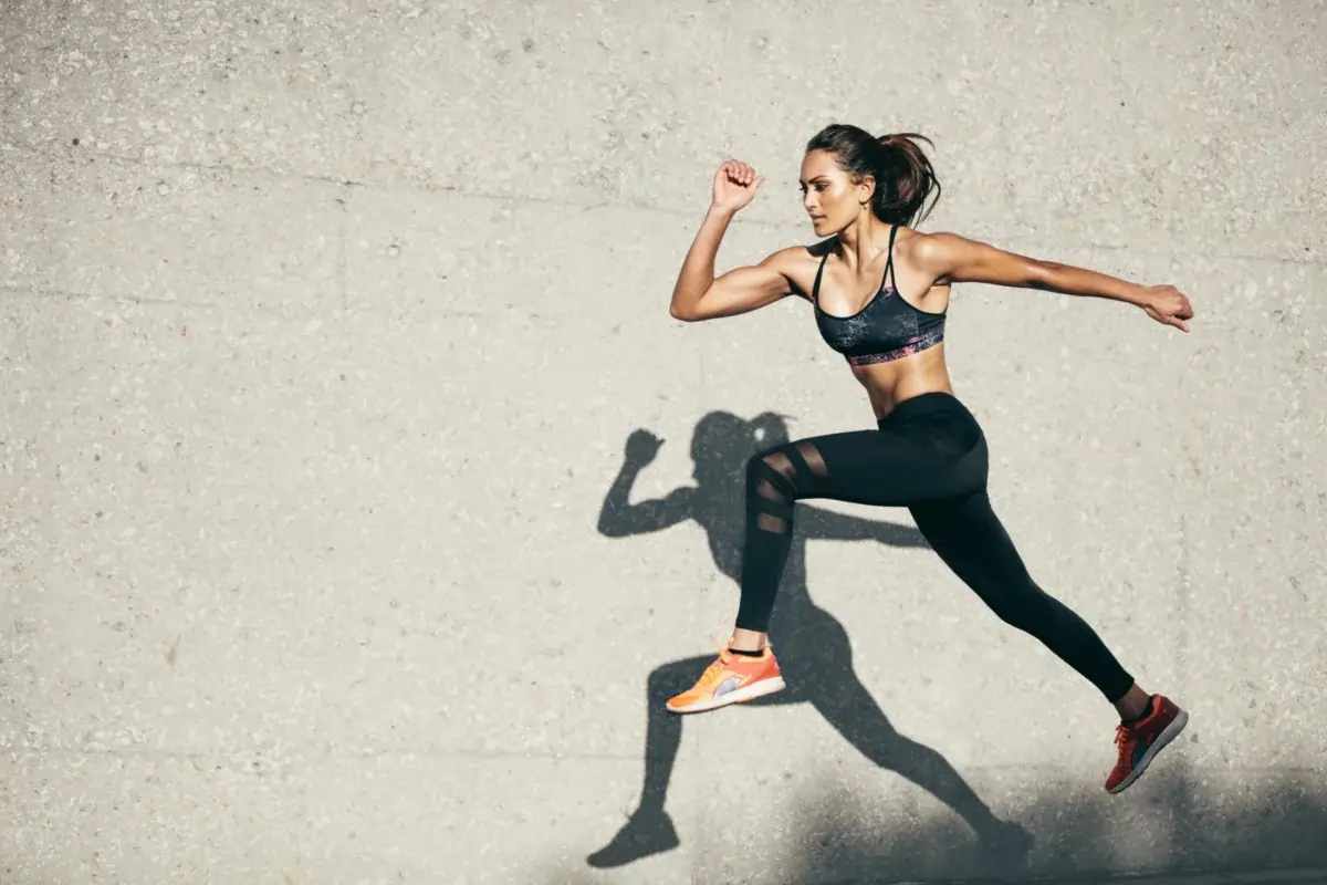 Athletic woman running in motion, symbolizing energy and vitality after Peptide Therapy for sexual wellness.