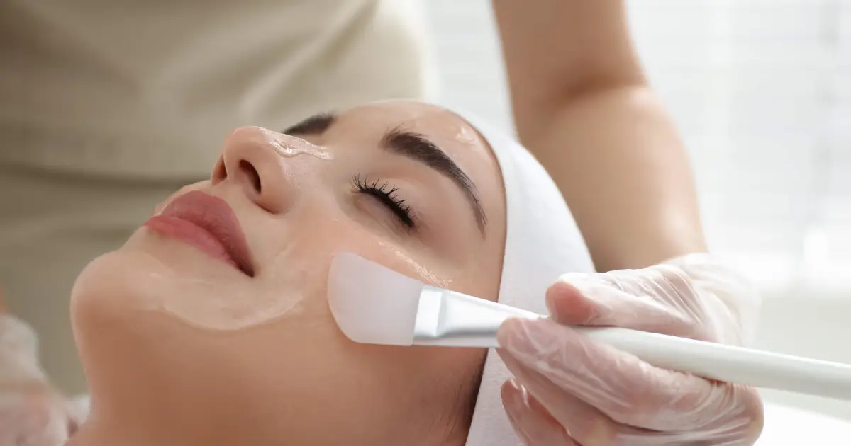 Woman receiving a medical-grade chemical peel facial treatment for skin renewal in Sioux Falls