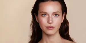 a woman with long hair and a radiant face with medical aesthetic treatments