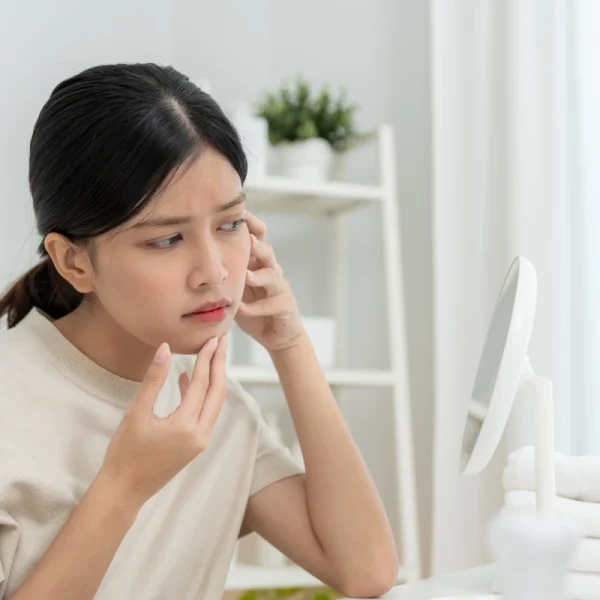 Woman with fine lines considering Botox for early facial aging.